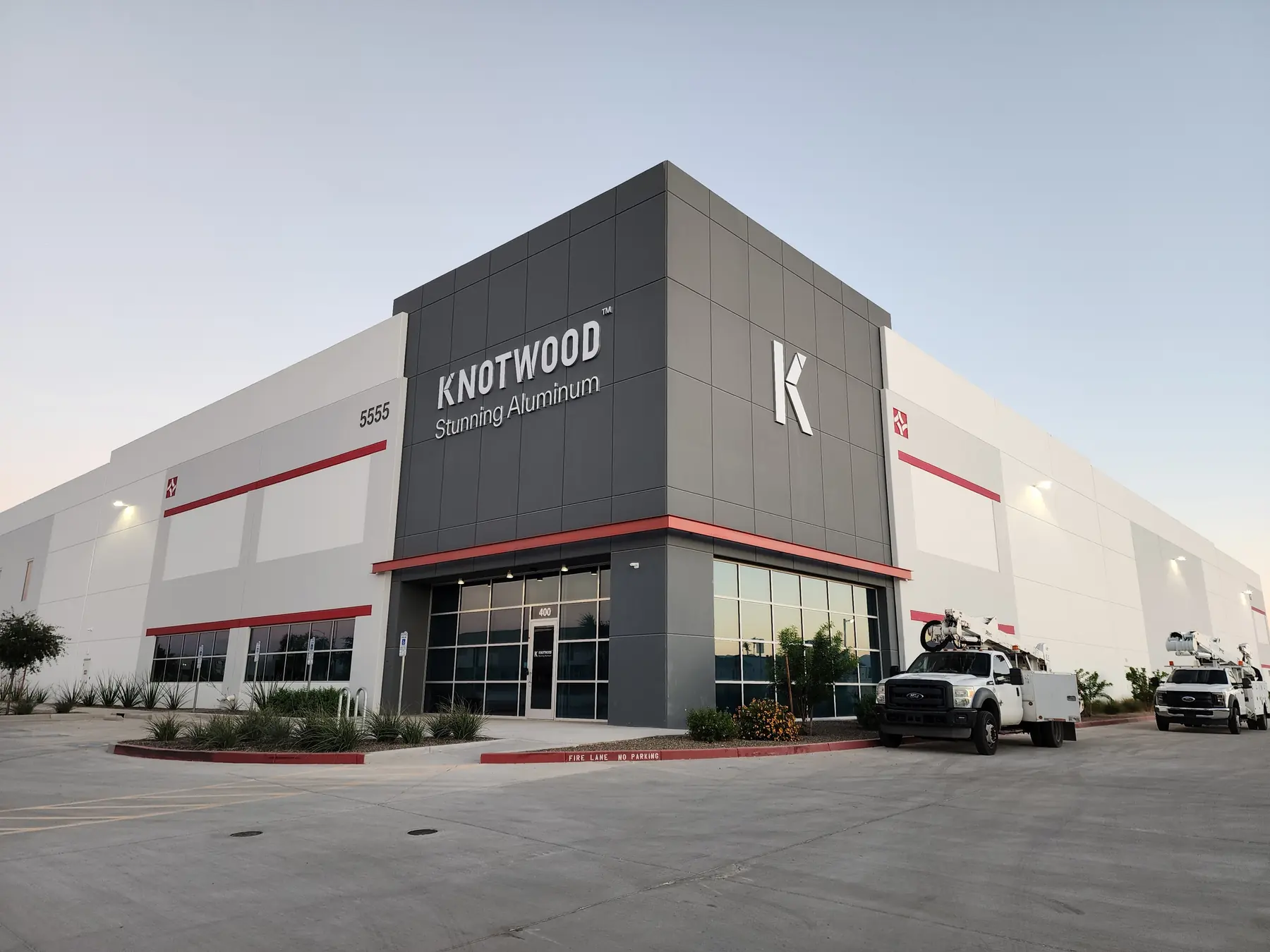 Knotwood building signage with installation trucks outside